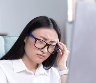 close up photo of business woman tired in office  with headache