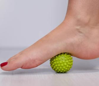 foot steps on massage ball to relieve plantar fasciitis