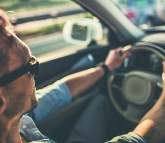 man behind steering wheel