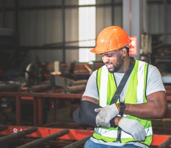 Construction worker with his arm in a sling