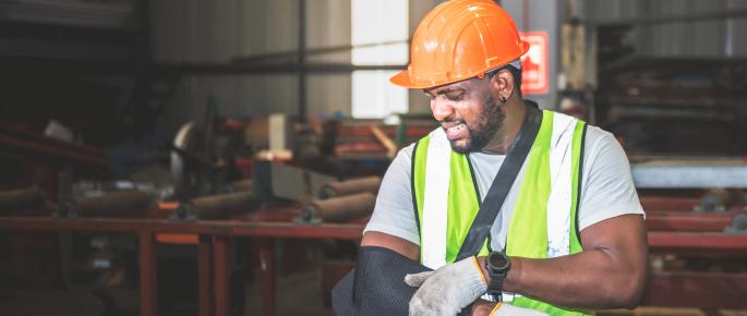 Construction worker with his arm in a sling