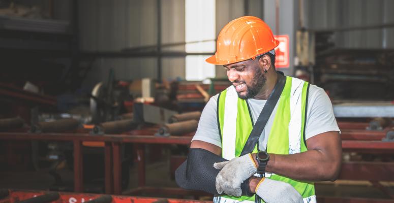 Construction worker with his arm in a sling